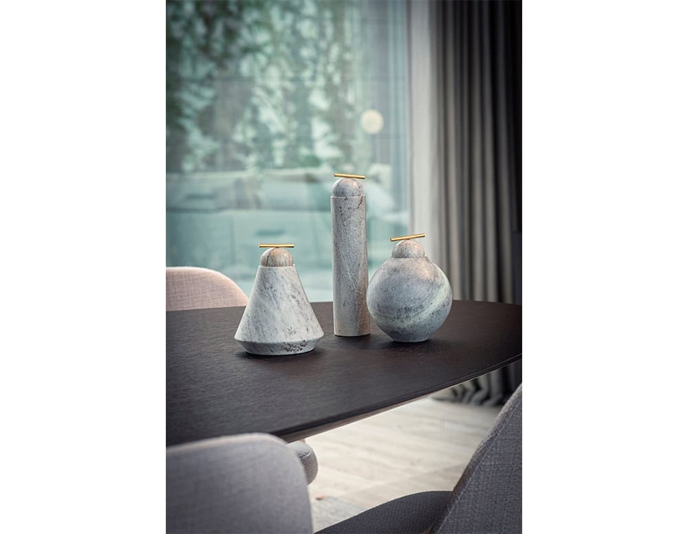 AOI Vase combines sculptural stone forms in soft gray tones, accented with polished brass details, creating an elegant balance of minimalism and artistry.