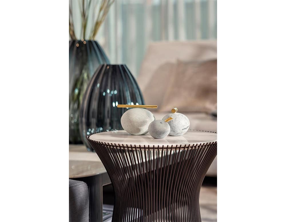 Bola Sabao Accessories are crafted in soft stone tones with brass accents, offering a minimalist sculptural presence that elevates modern interiors.