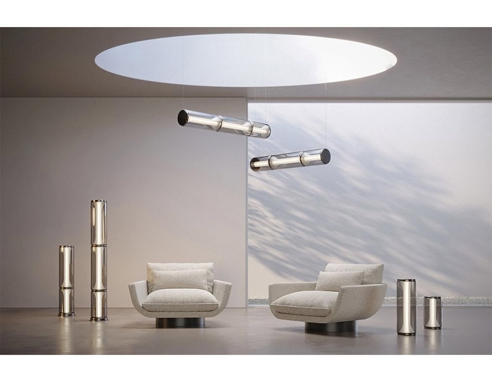Las Miles Lighting combines suspended smoked glass cylinders and standing columns with soft warm illumination, creating a modern sculptural ambiance in the space.