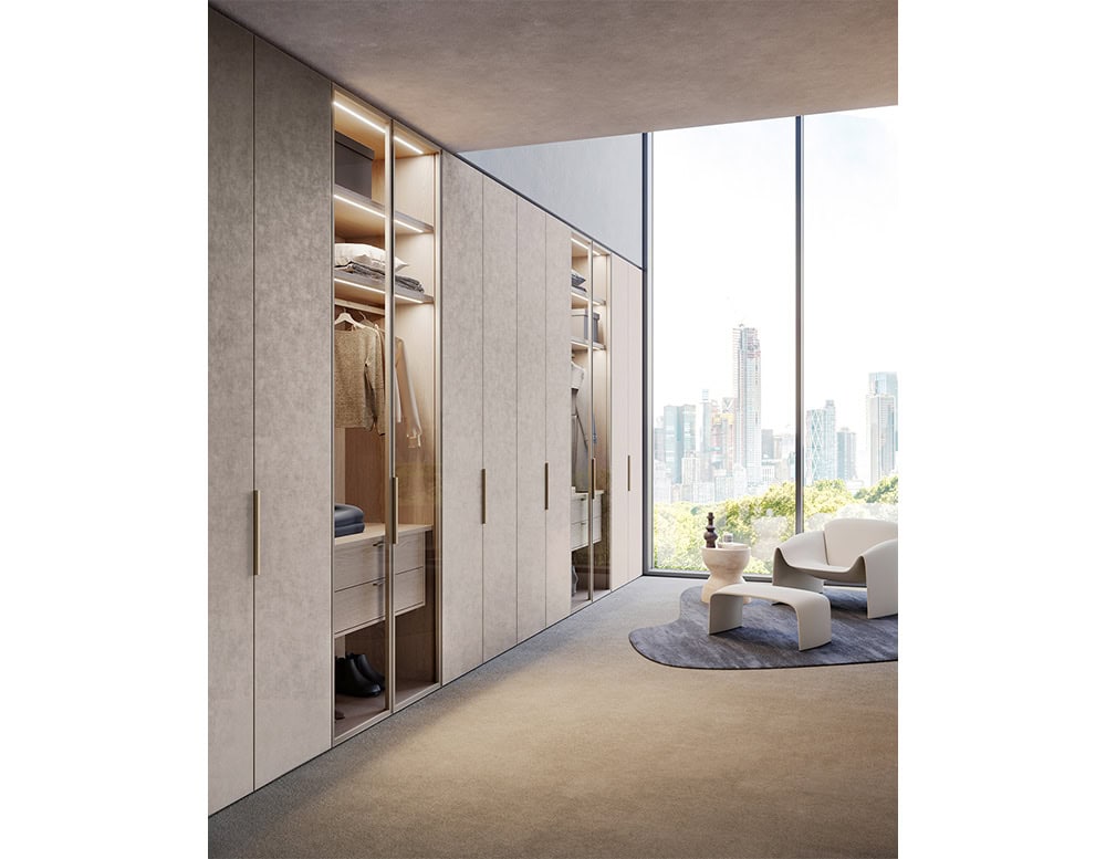 Designed to maximize storage while maintaining a refined aesthetic, this wall unit combines concealed cabinetry with open illuminated displays for a contemporary edge.