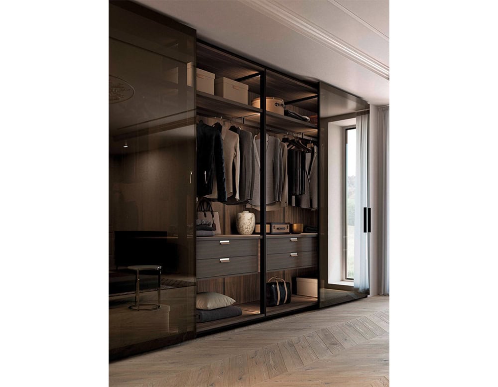 A modern storage concept with glass-fronted panels and tailored compartments, designed to showcase clothing and accessories while maintaining a clean, architectural aesthetic.