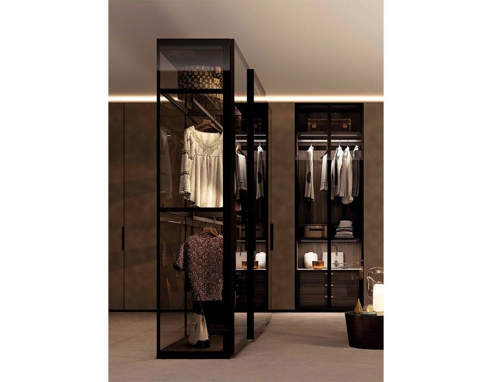 This freestanding glass wardrobe creates a boutique-like experience, showcasing garments and accessories with dramatic lighting and elegant framing.