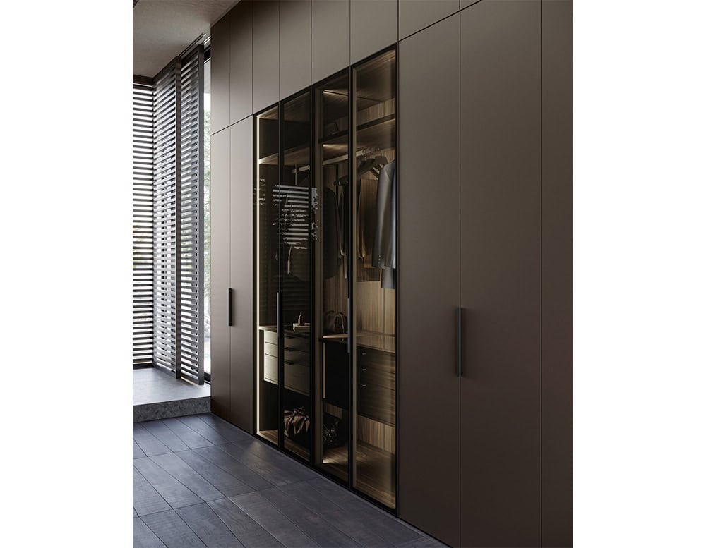 Designed for both functionality and style, this wall unit features illuminated compartments, soft finishes, and integrated handles to create a sophisticated, seamless look.