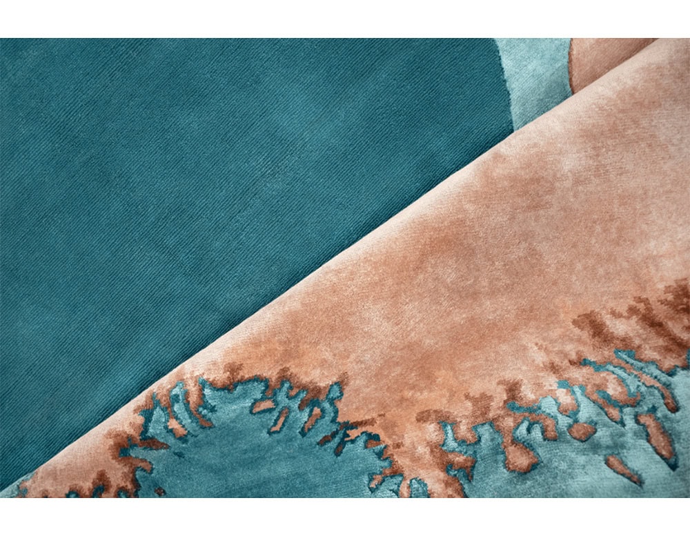 The Sah Bonsai Rug blends oceanic turquoise with warm beige tones, highlighted by intricate textures. Its organic design adds depth and a sense of nature’s flow to modern spaces.