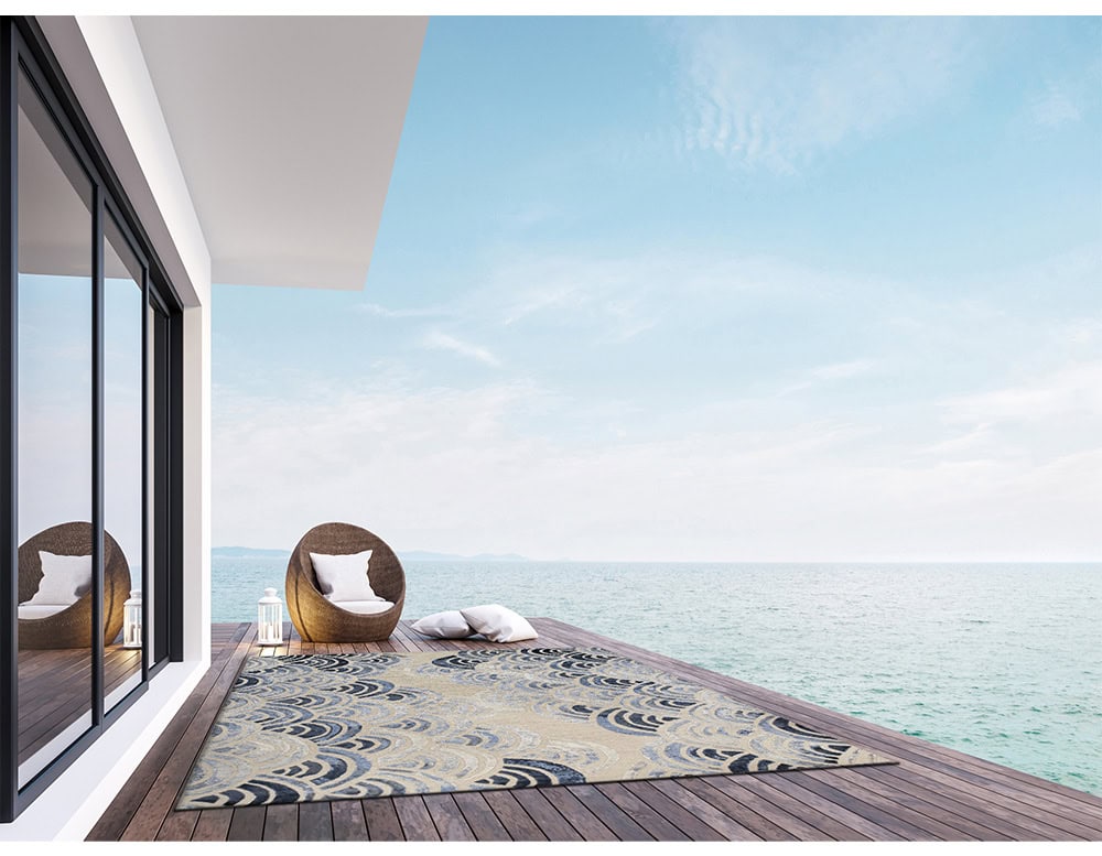 Placed by the sea, this rug enhances the view with its wave-like arcs in soft cream and deep blue. Its fluid design mirrors the ocean, creating a serene and elegant connection to nature.