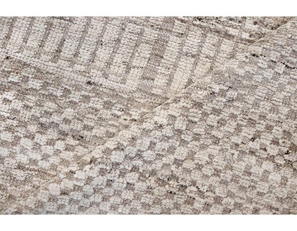 Sah Sidi Rug highlights a handwoven grid texture with natural tones. Its soft, artisanal finish creates warmth and subtle sophistication, making it a timeless accent for modern and traditional spaces alike.