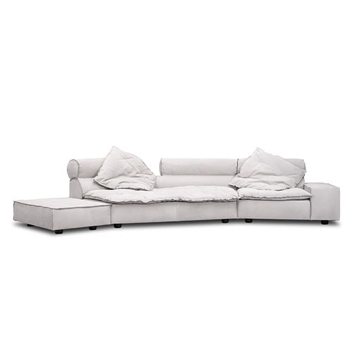 A low profile sofa with deep seats and oversized cushions in light gray fabric, designed to create an inviting atmosphere with a casual yet refined aesthetic perfect for modern interiors.