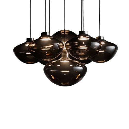 A contemporary pendant light composed of seven smoked glass shades clustered together, creating a warm, elegant glow and a sculptural focal point perfect for modern interiors.