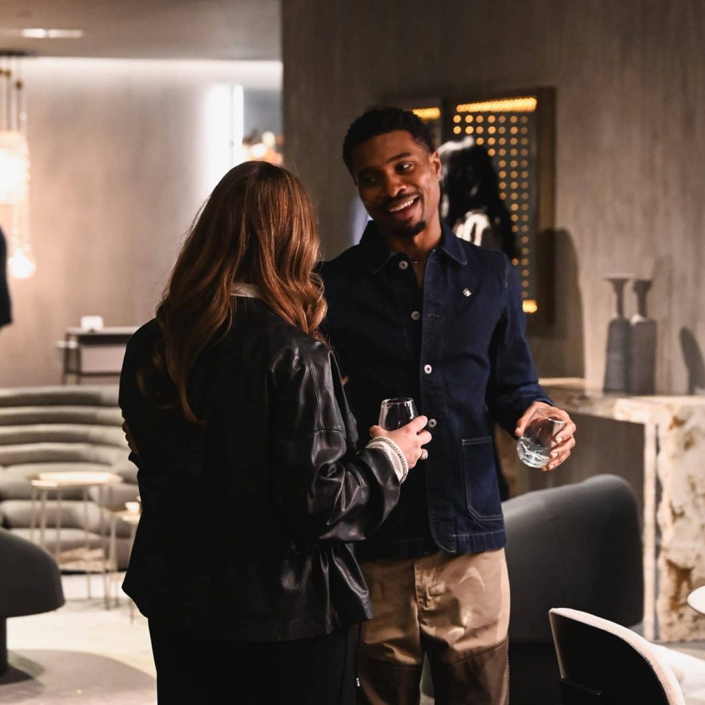 A relaxed moment on the showroom floor, where guests connect over drinks and conversation, surrounded by curated design and a welcoming atmosphere.