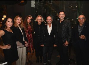 A stylish group gathers for a photo, enjoying the lively atmosphere of the showroom event. Their smiles and ease reflect the welcoming spirit of the night surrounded by design and good company.