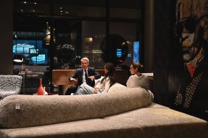 Guests relax into a thoughtful conversation, enjoying the cozy setting and elegant design pieces that shape the inviting mood of the showroom.