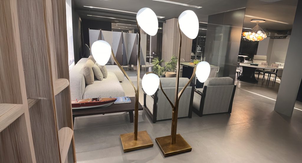 Sculptural floor light with branching bronze stems and softly glowing white glass shades. The warm metallic finish paired with diffused white tones creates an elegant ambient presence, ideal for adding warmth and visual balance to modern interiors.