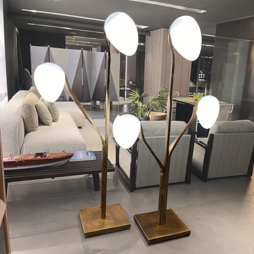 Sculptural floor light with branching bronze stems and softly glowing white glass shades. The warm metallic finish paired with diffused white tones creates an elegant ambient presence, ideal for adding warmth and visual balance to modern interiors.