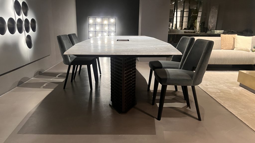 S Penny dining table with a light stone top and sculptural dark base showcasing clean lines refined proportions and a balanced contrast of soft gray and deep charcoal tones designed for elegant contemporary dining spaces.