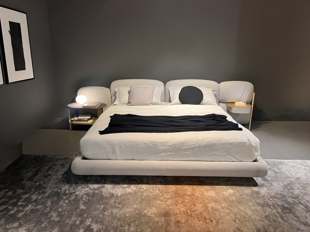 Stone Bed by Baxter featuring a generously padded frame with rounded edges and modular headboard elements offering a calm inviting presence with plush comfort and a contemporary silhouette designed for elegant modern sleeping spaces.