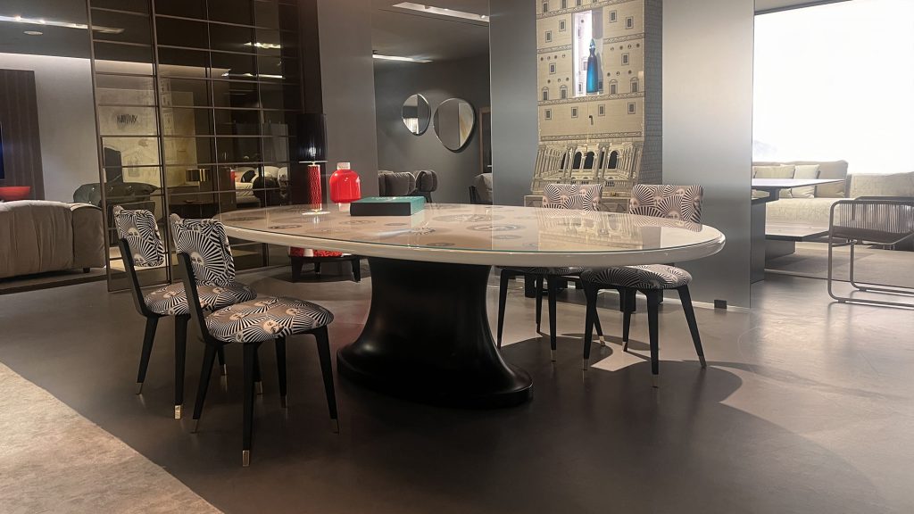 The Soli e Lune table by Fornasetti features an elegant oval top illustrated with the brand’s iconic celestial faces paired with a sculptural pedestal base creating a striking balance of artistic expression and functional design.