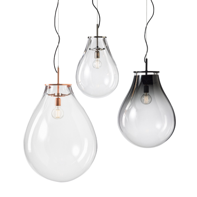 Elegant suspension lights featuring softly rounded glass shades in clear and smoked finishes. Paired with refined metal details, they create a light, airy presence while showcasing the bulb as a central design element.