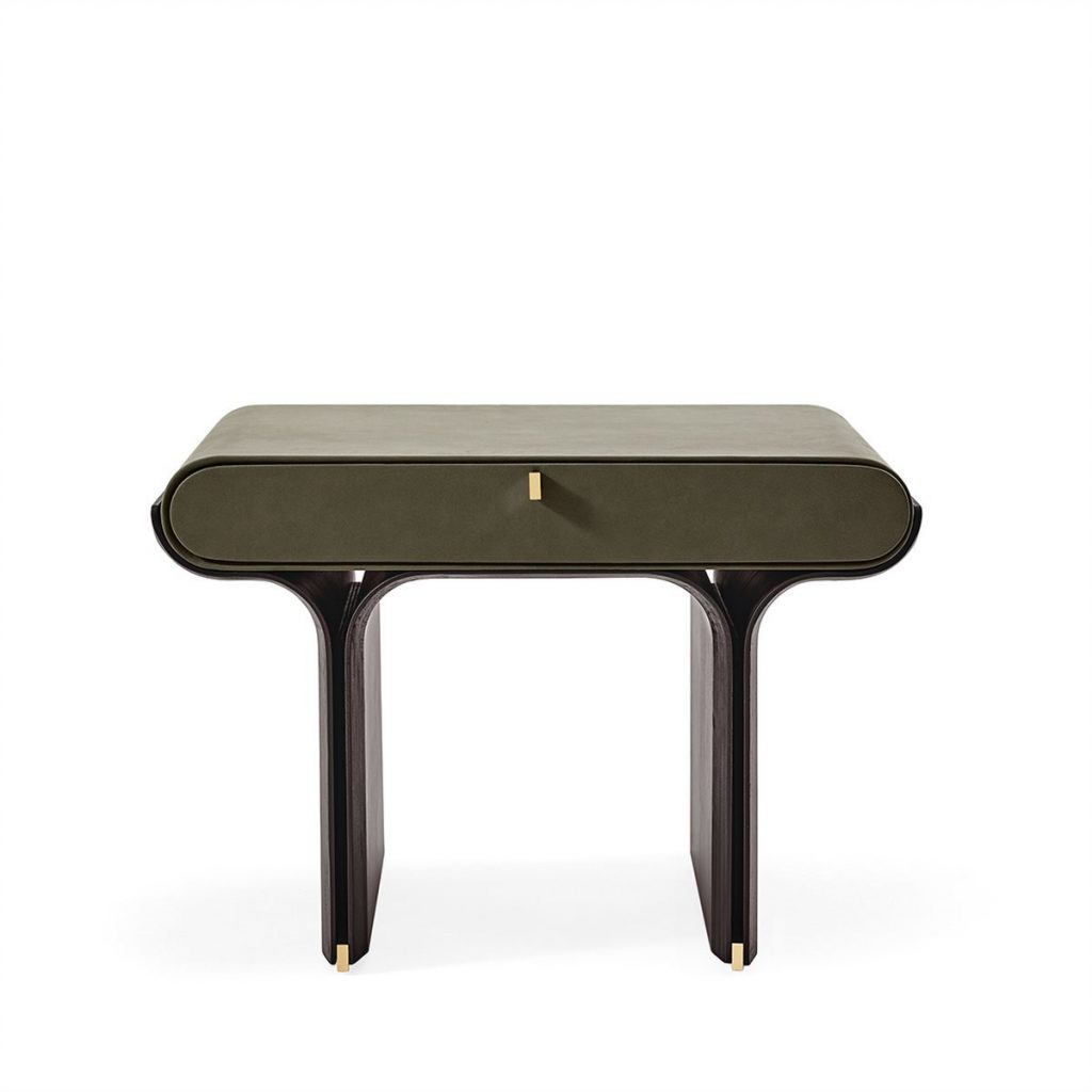 A modern bedside table featuring an olive green drawer with a small brass pull, set on a sleek dark wood base with curved legs. The clean silhouette and refined materials create a calm, sophisticated accent for contemporary interiors.