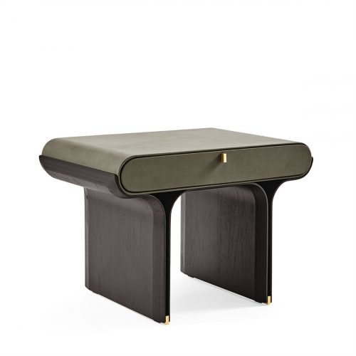 A compact night table with a soft olive green top and rounded edges, paired with dark wood legs and subtle brass accents. Its sculptural base and single drawer blend elegance and function, ideal for refined bedroom settings.