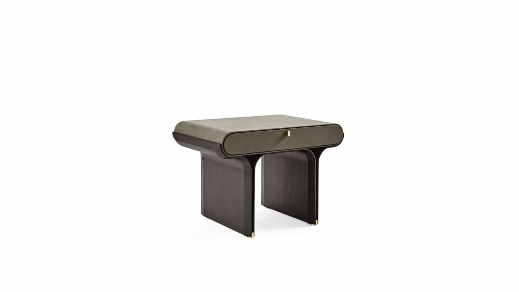 A refined nightstand with a soft olive green drawer front and rounded edges. The dark wood base features sculpted legs with subtle gold accents, creating a balanced contrast of deep brown, muted green, and warm metallic details.